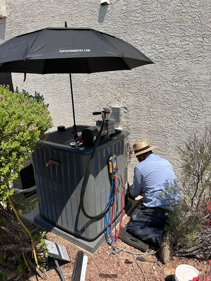 HVAC technician performing outdoor AC maintenance in Blaine